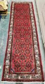 North west Persian red ground Malayer Runner with repeating lozenge and floral pattern, floral