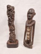 Two African tribal carvings, one of a man and the other of group of figures, the largest 73cm high