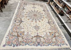 Central Persian Kashan cream ground carpet with large central floral medallion enclosed by hanging