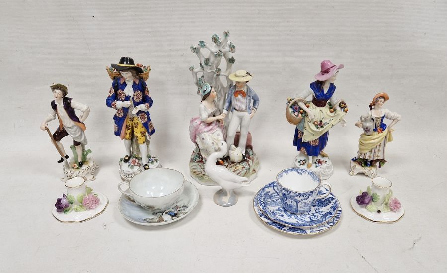 Group of Continental porcelain figures including a gentleman and companion each carrying baskets