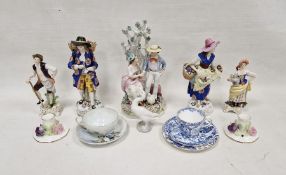 Group of Continental porcelain figures including a gentleman and companion each carrying baskets