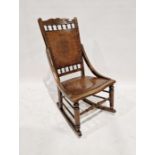 Oak rocking chair with wooden panelled back and seat