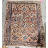 Eastern orange ground rug with three rows of six geometric medallions on floral field, multiple