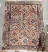 Eastern orange ground rug with three rows of six geometric medallions on floral field, multiple