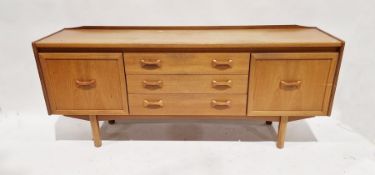 Mid century teak sideboard by William Lawrence comprising two single cupboard doors opening to