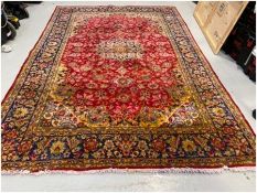 Eastern red ground carpet with central floral medallion on floral field with floral spandrels,