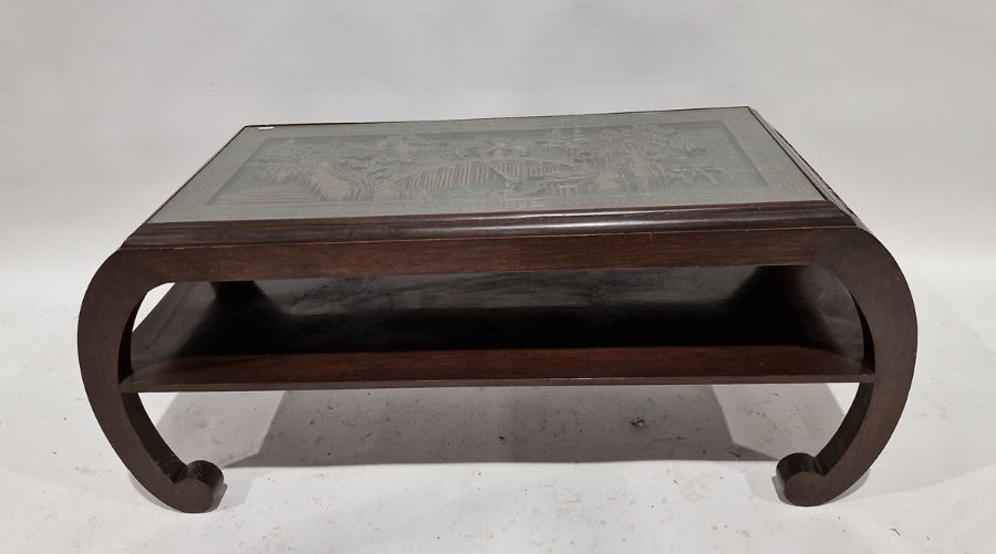 Chinese hardwood and glass-topped coffee table, the rectangular top carved with a scene of figures