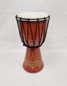 African rope-bound djembe drum in red stained wood with carved decoration 50cm high x 27cm diameter