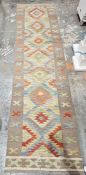 Turkish Anatolian orange ground Kilim with seven central stepped lozenge medallions interwoven