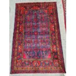 North west Persian red ground Hamadan rug with six central hooked lozenge medallions on floral