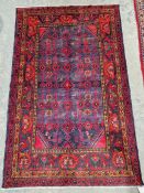 North west Persian red ground Hamadan rug with six central hooked lozenge medallions on floral