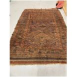 Large eastern red/brown ground rug with three central geometric medallions on divided geometric