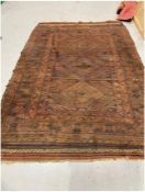 Large eastern red/brown ground rug with three central geometric medallions on divided geometric