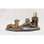 Art Deco figure group depicting a seated lady in period dress, beside a dog, the lady holding a hand