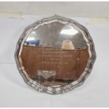 LOT WITHDRAWN Silver salver with gadrooned serpentine border, inscription to top, on three scroll