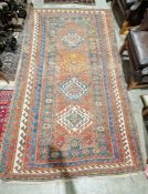 Eastern red ground rug with four lozenge shaped geometric medallions on geometric shape field,