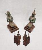 Two 20th century Buddhist figures depicting a male and female kneeling in prayer, both raised on