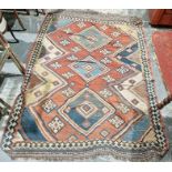 LOT WITHDRAWN Large red ground rug with three central stepped lozenges surrounded by hooked