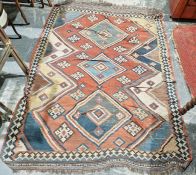 LOT WITHDRAWN Large red ground rug with three central stepped lozenges surrounded by hooked