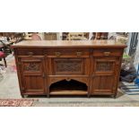 Early 20th century oak sideboard, with two short and one long drawer, over a drop front cupboard and