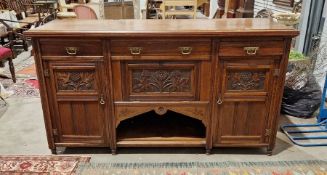 Early 20th century oak sideboard, with two short and one long drawer, over a drop front cupboard and