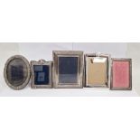 Collection of four silver mounted photograph frames and another, four of rectangular form, the other