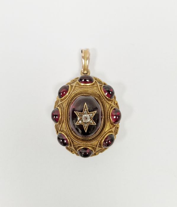 Victorian gold oval pendant set with garnet cabochons and an old cut diamond, 14.5g approx. in total