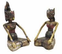 Pair of 20th century carved wooden Asian figures depicting a male and female, each wearing
