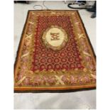 Large Aubusson red ground rug with central M motif on oval medallion over geometric field, single