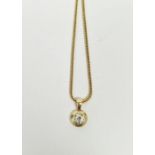 18ct gold and diamond pendant on chain necklace, the diamond in circular mount, 5mm diameter