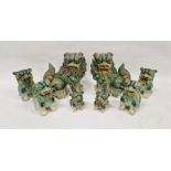 Collection of eight pottery Chinese-style models of dogs of fo, each glazed in mottled green,