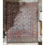 Eastern blue ground rug with central geometric trelliswork, multiple geometric and floral borders