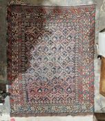 Eastern blue ground rug with central geometric trelliswork, multiple geometric and floral borders