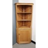 Ercol blonde windsor corner cabinet with three shelves above cupboard below, 177cm high