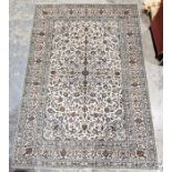Central Persian cream ground Kashan carpet with central floral medallion on floral field, floral