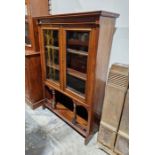 20th century mahogany display unit with glazed cupboards enclosing three shelves over arched and