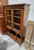 20th century mahogany display unit with glazed cupboards enclosing three shelves over arched and