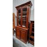 20th century mahogany bookcase with glazed cupboard above enclosing four shelves, drawer and panel