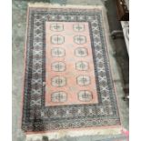 Pakistani hand knotted peach ground wool pile rug with two rows of six elephant foot guls,