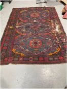 Eastern mauve and  blue ground carpet with three large geometric medallions on geometric shape field