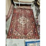 Large Eastern style pink ground rug with central lozenge medallion on a herati-filled field with