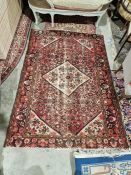 Large Eastern style pink ground rug with central lozenge medallion on a herati-filled field with