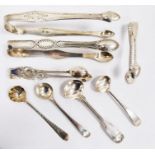 Four silver sugar tongs and four silver spoons, various dates and makers, 128.5g, 4ozt approx. in