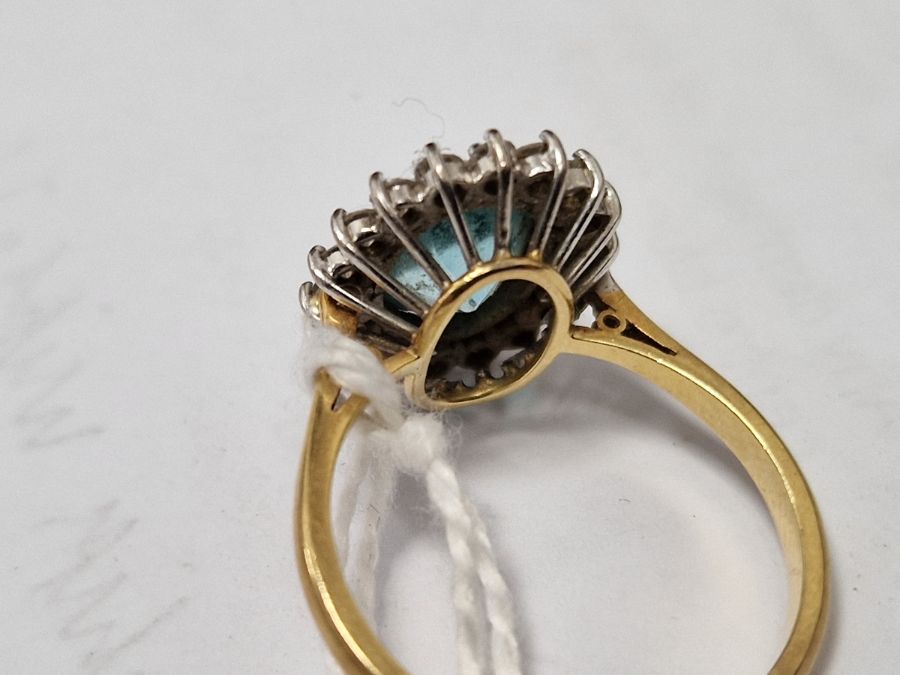 18ct gold yellow gold, diamond and blue stone ring, the oval central stone aquamarine in colour - Image 8 of 8