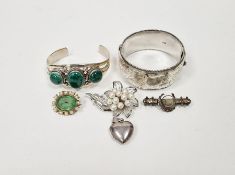 Silver bangle with engraved decoration, a foreign silver-coloured metal and malachite bangle, a
