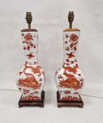 Two modern Chinese-style lamp bases, printed in iron red with scrolling dragons chasing flaming