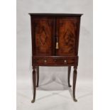 Empire-style bowfronted cabinet on stand, having single shelf enclosed by pair panelled doors with