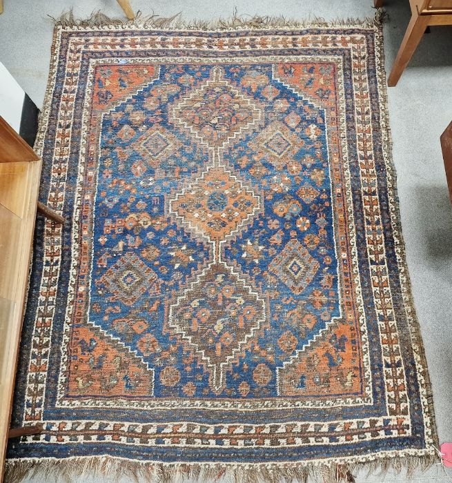 Eastern blue ground rug with three central geometric joined medallions on floral and geometric shape