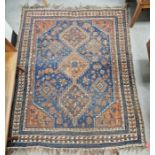 Eastern blue ground rug with three central geometric joined medallions on floral and geometric shape