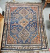 Eastern blue ground rug with three central geometric joined medallions on floral and geometric shape